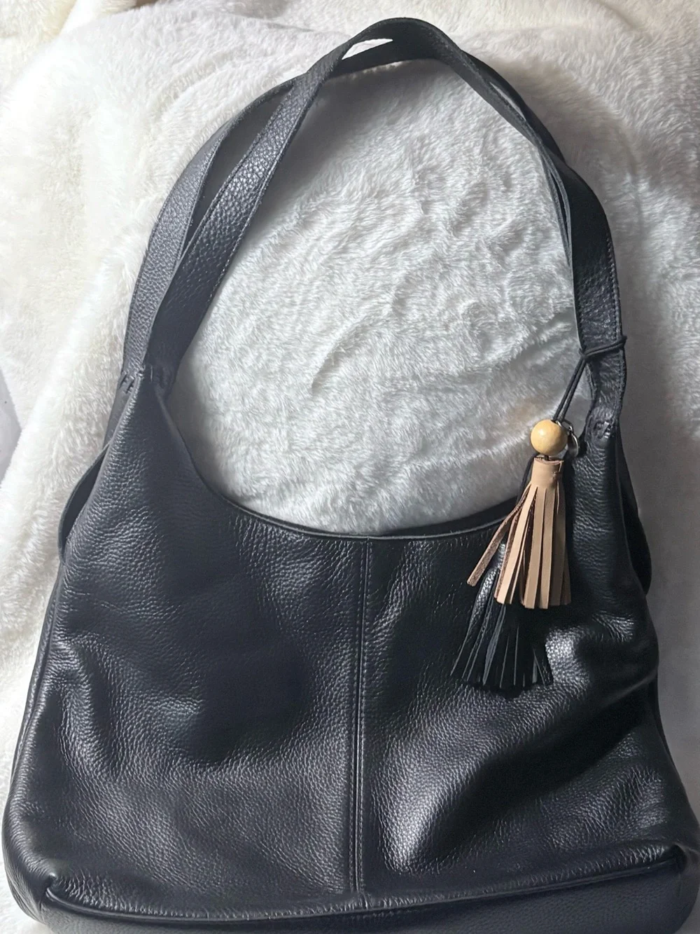 The Sak Black Leather Shoulder Bag with Tan Tassel Charm